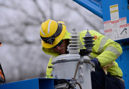 The workers are repairing the transformer